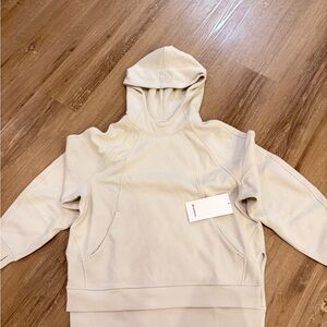 This is a Lululemon Scuba Oversized Side-Slit Hoodie in the color Bone.